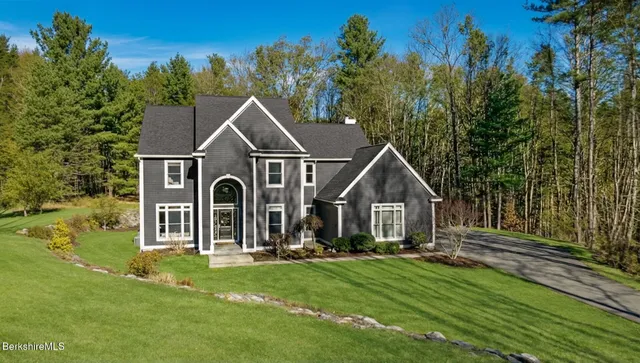 a front view of a house with a yard