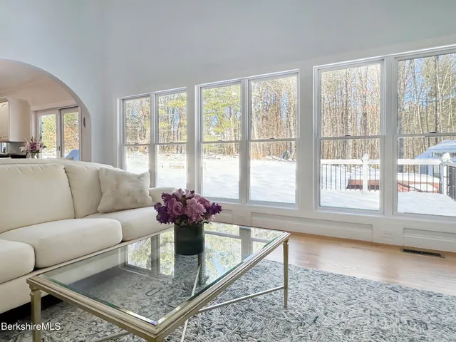 a living room with furniture and floor to ceiling windows