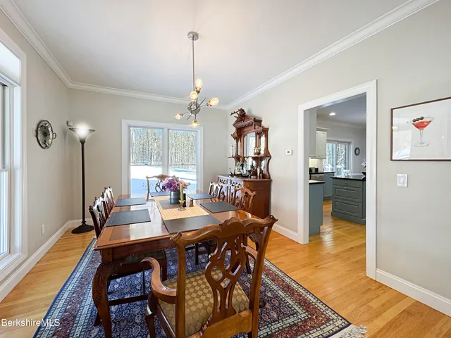 a view of a dining room filled with furniture and wooden floor