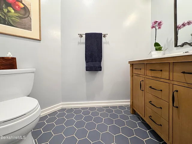 a bathroom with a toilet and a shower curtain