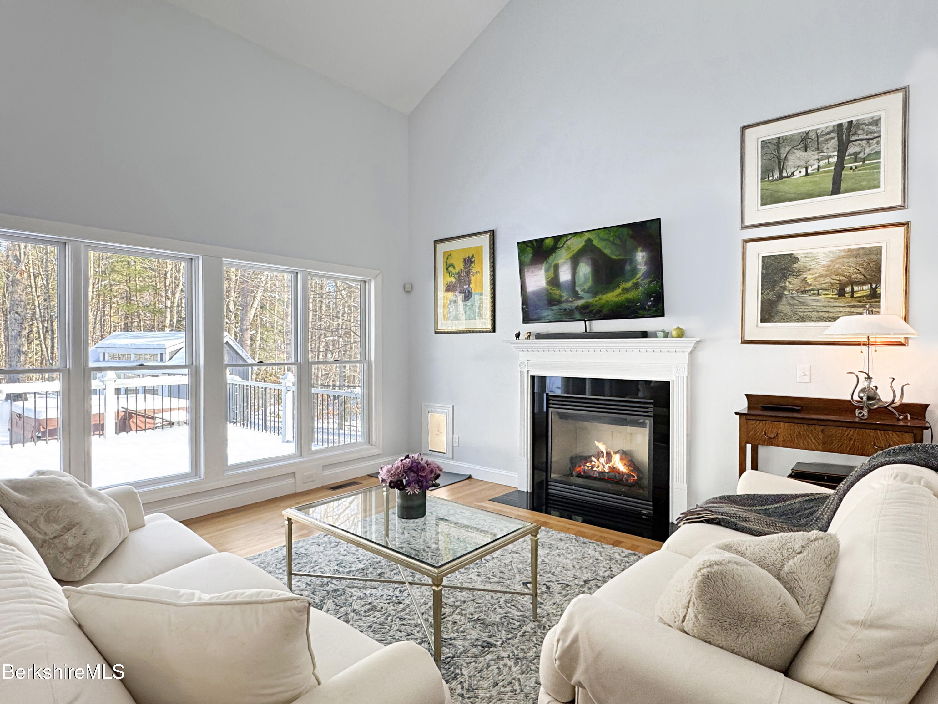 5 Eastbrook Lane Pittsfield, MA 01201 - Photo 9 of 43 a living room with furniture a flat screen tv and a fireplace