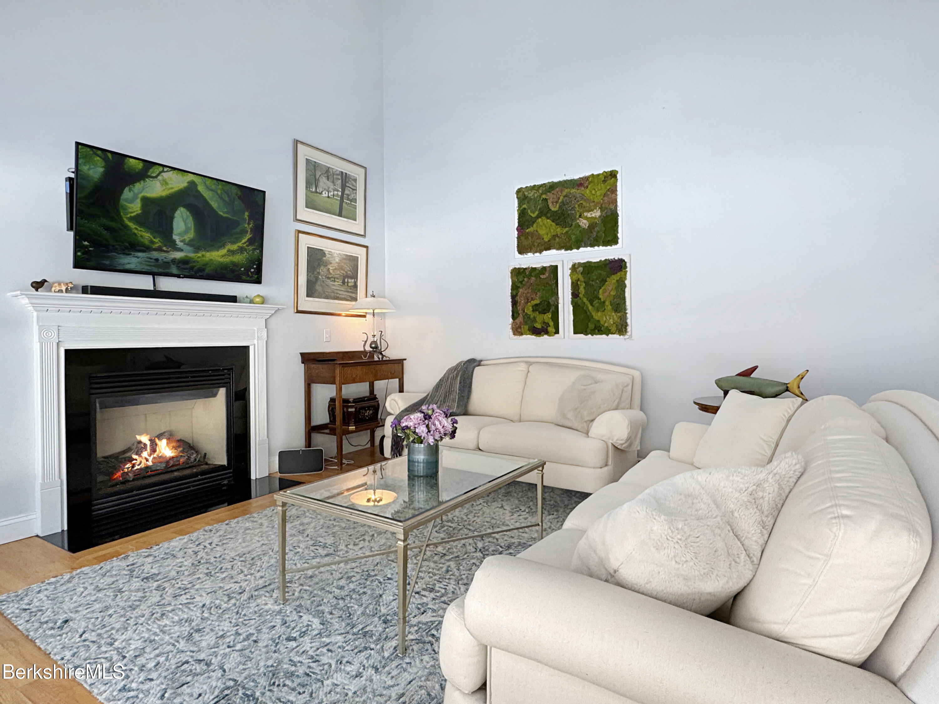 5 Eastbrook Lane Pittsfield, MA 01201 - Photo 10 of 43 a living room with furniture a flat screen tv and a fireplace