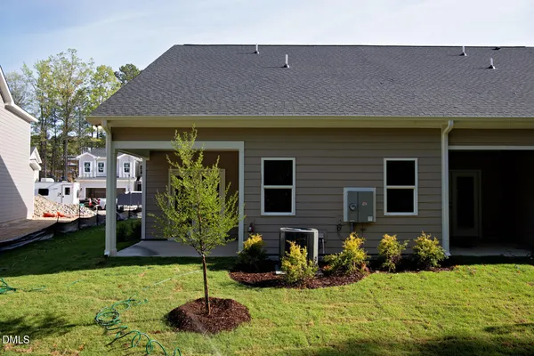 a brick house with potted plants in front of it