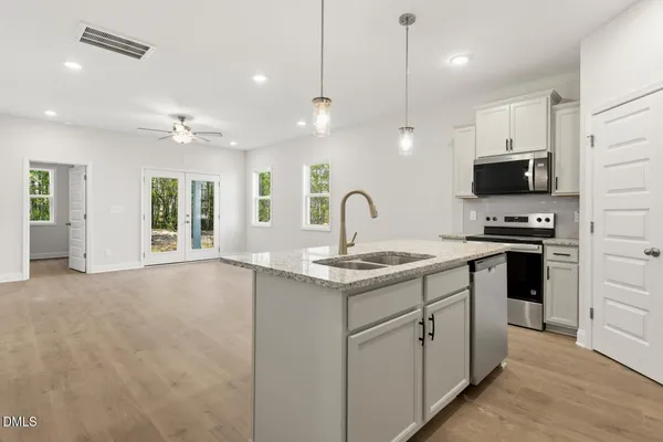 a kitchen with a sink stove and microwave