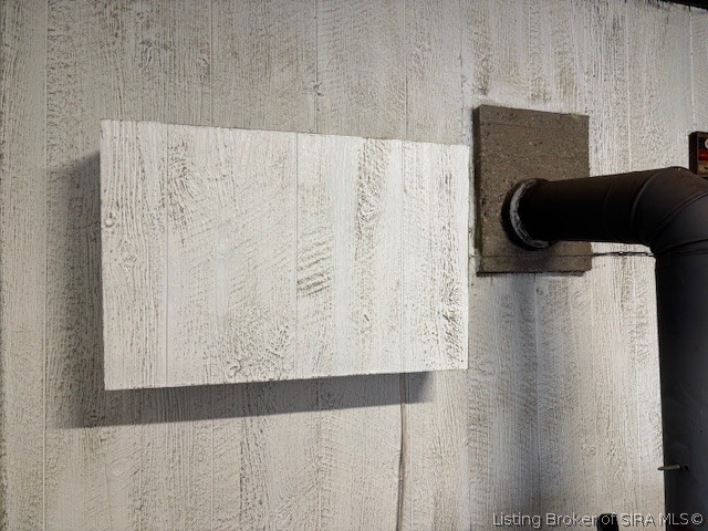 6024 Little Patoka Road Taswell, IN 47175 - Photo 17 of 26 1 of the 2 window a/c units is behind the wooden box next to the wood stove