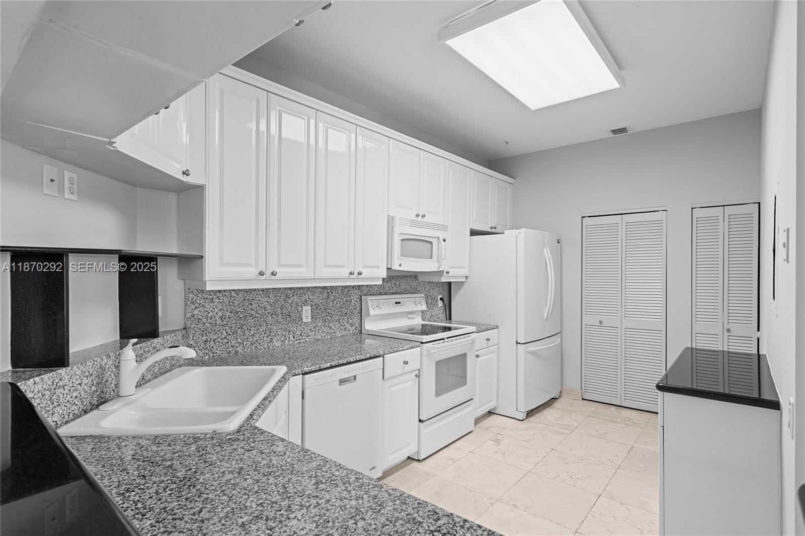 888 Brickell Key Drive, Unit 408 Miami, FL 33131 - Photo 26 of 55 a kitchen with stainless steel appliances granite countertop a sink stove and refrigerator