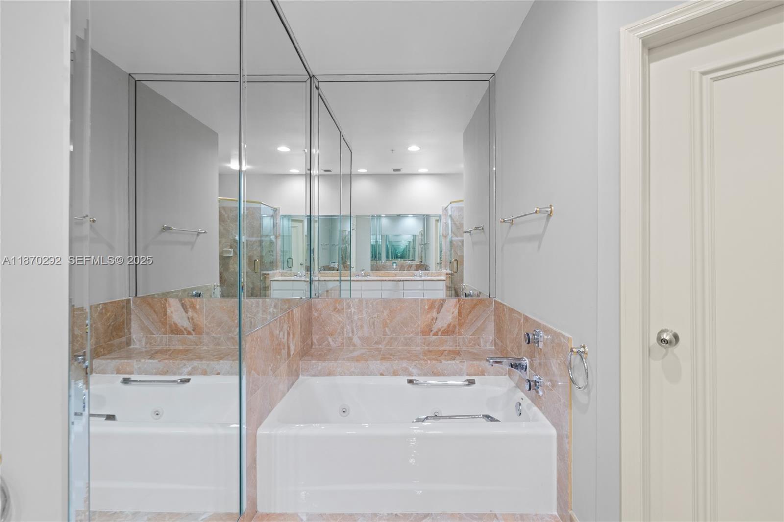 888 Brickell Key Drive, Unit 408 Miami, FL 33131 - Photo 38 of 55 a bathroom with a bathtub and a shower