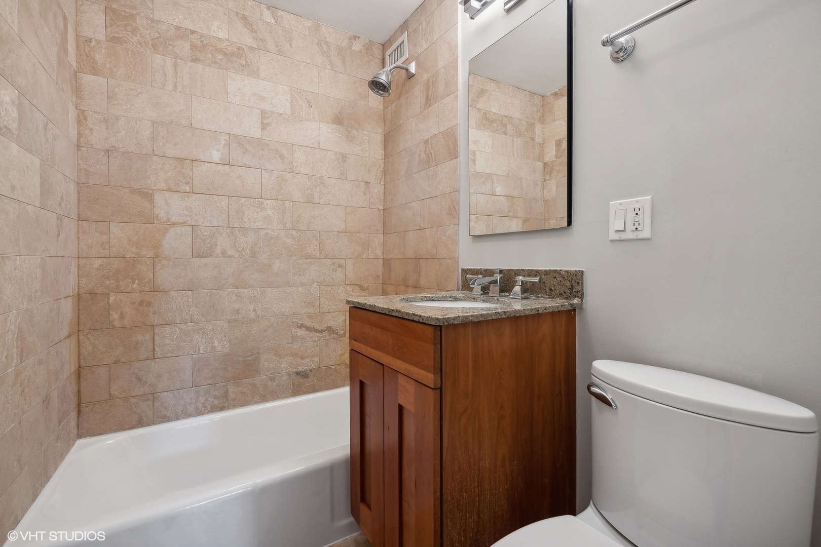 2930 North Sheridan Road, Unit 301 Chicago, IL 60657 - Photo 11 of 20 a bathroom with a granite countertop toilet sink and bathtub