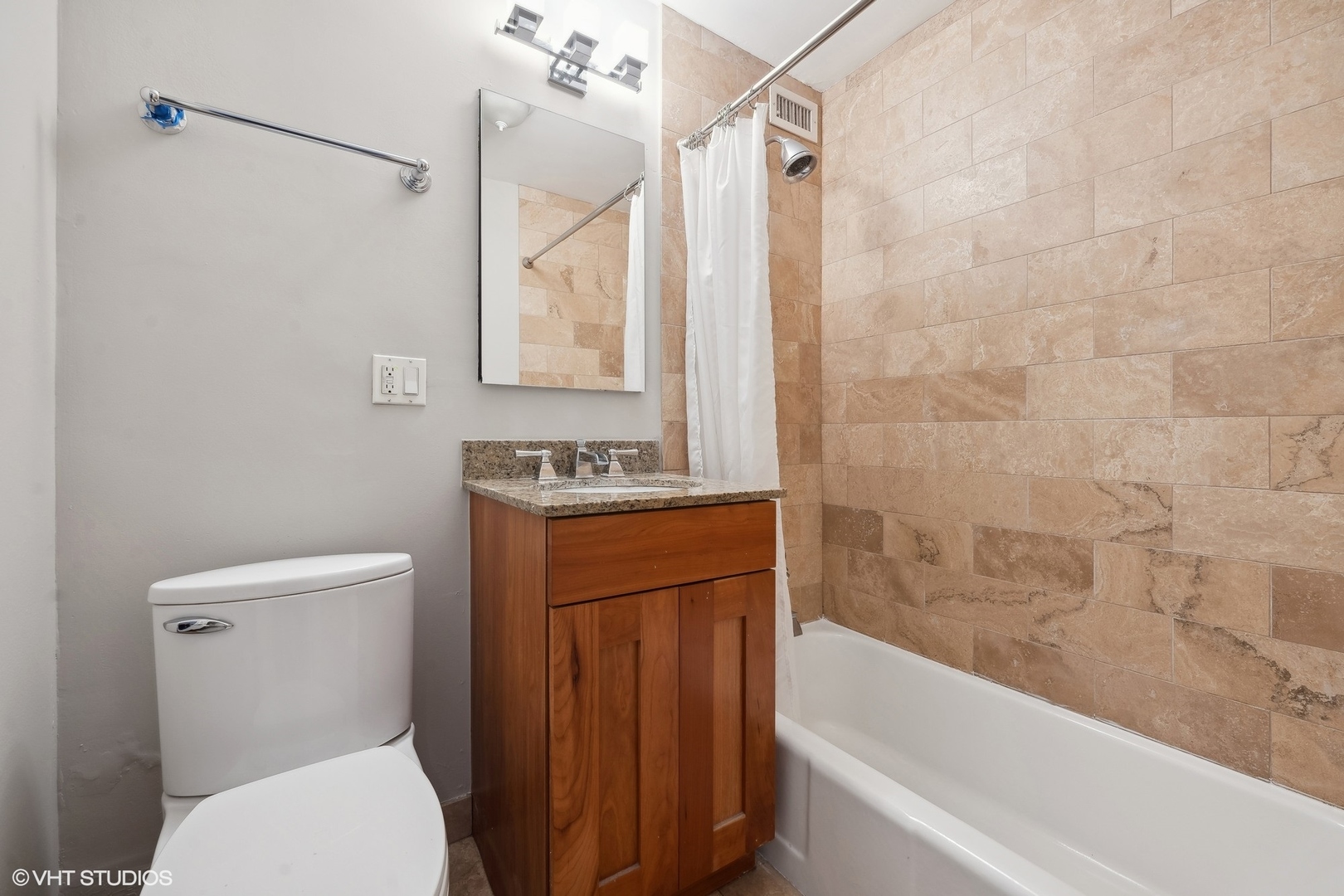2930 North Sheridan Road, Unit 301 Chicago, IL 60657 - Photo 13 of 20 a bathroom with a granite countertop toilet sink and bathtub