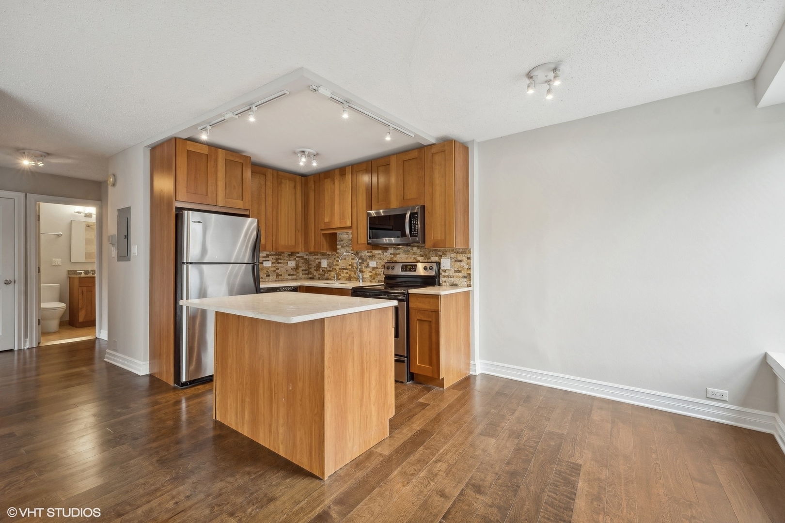 2930 North Sheridan Road, Unit 301 Chicago, IL 60657 - Photo 3 of 20 a kitchen with stainless steel appliances granite countertop a refrigerator stove top oven and sink