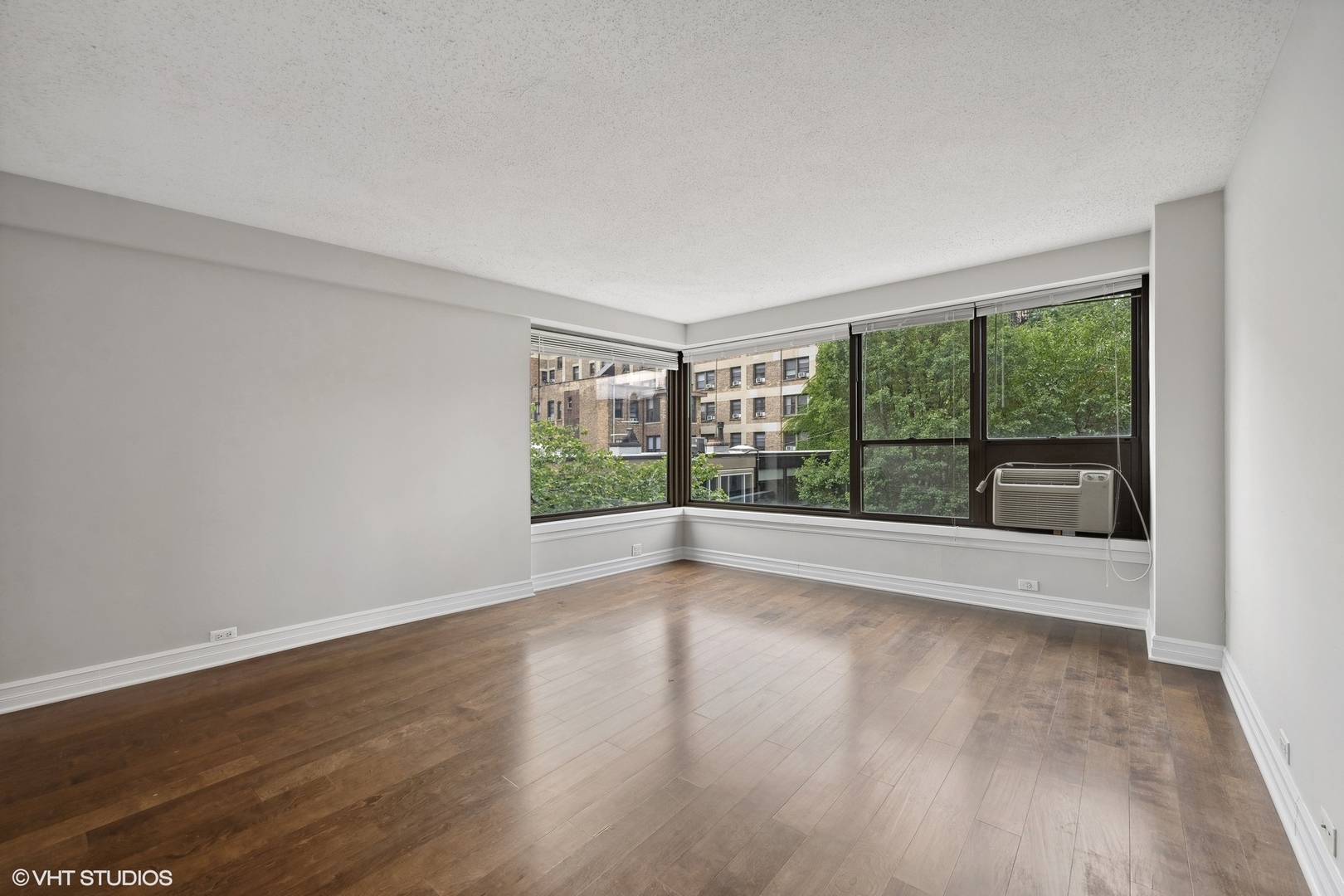 2930 North Sheridan Road, Unit 301 Chicago, IL 60657 - Photo 7 of 20 a view of empty room with wooden floor and fan