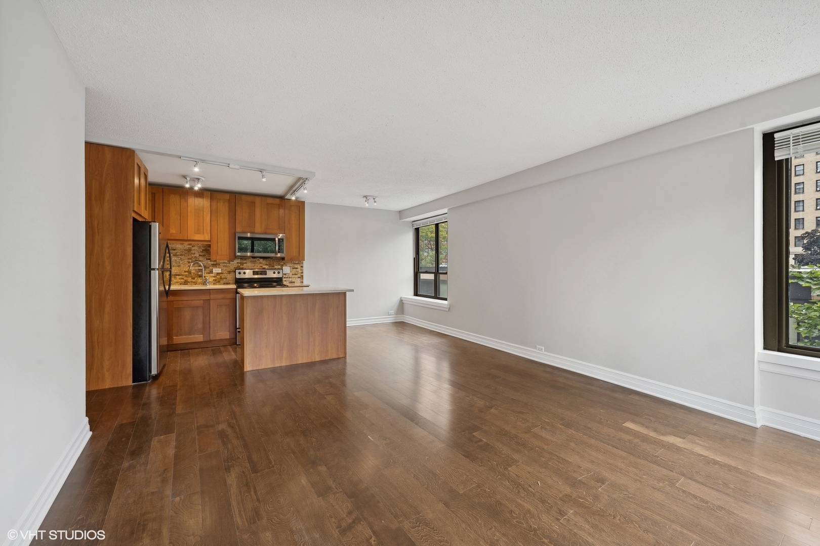 2930 North Sheridan Road, Unit 301 Chicago, IL 60657 - Photo 8 of 20 a view of kitchen with wooden floor electronic appliances and window