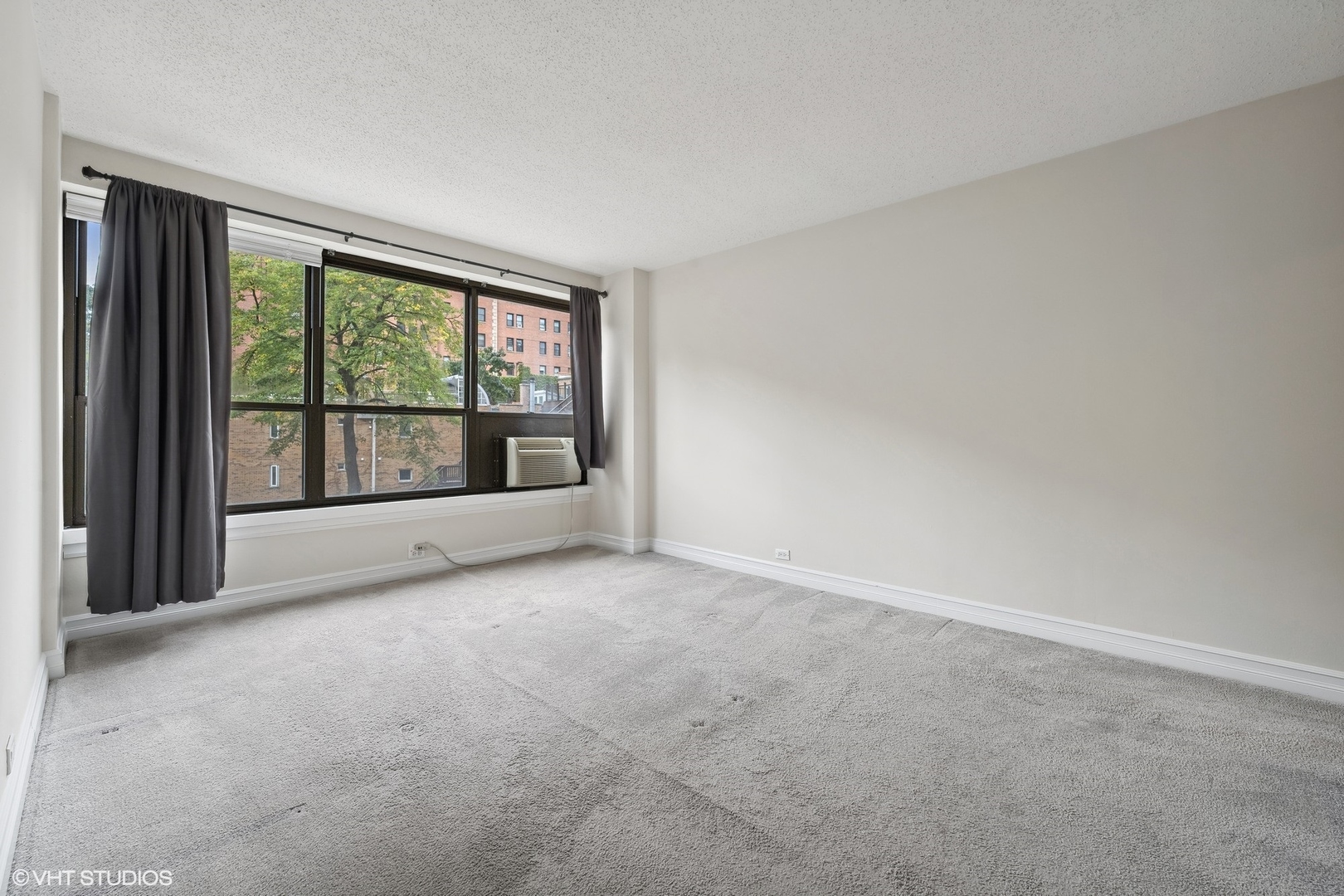 2930 North Sheridan Road, Unit 301 Chicago, IL 60657 - Photo 9 of 20 an empty room with large windows