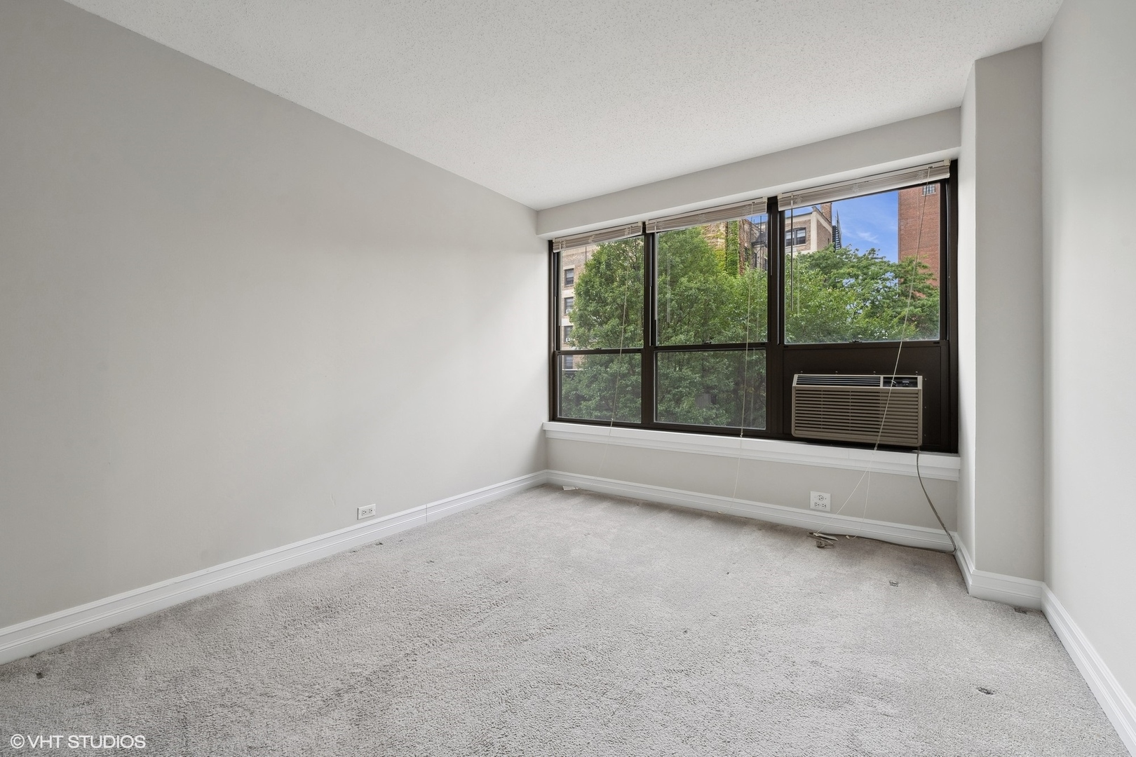 2930 North Sheridan Road, Unit 301 Chicago, IL 60657 - Photo 10 of 20 an empty room with large windows