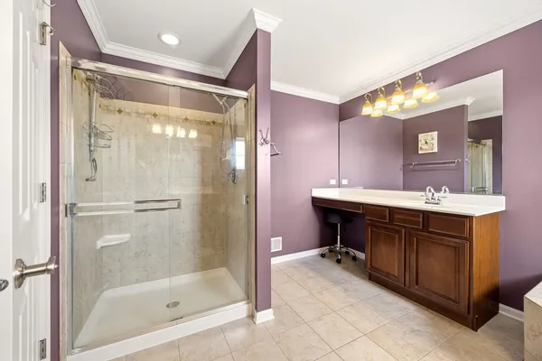a bathroom with a bathtub shower sink and mirror