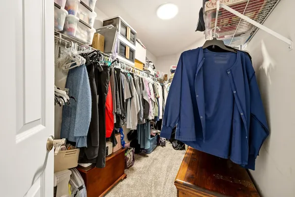 a view of walk in closet with clothes