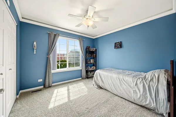 a bed sitting in a bedroom next to a window