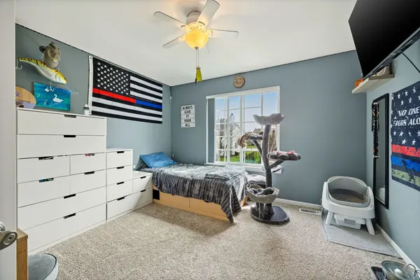 a bedroom with bed and a chandelier
