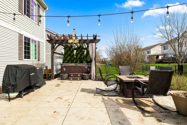 a view of a patio with a dining table and chairs