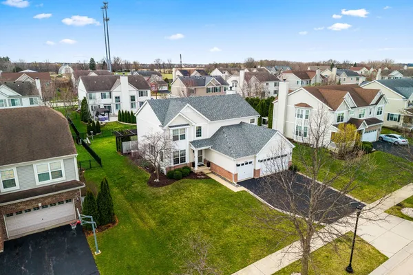 a aerial view of a house with swimming pool and a yard