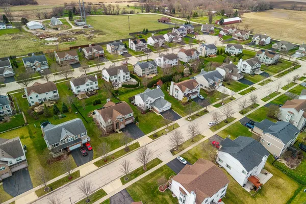 an aerial view of residential houses with outdoor space