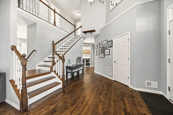 a view of entryway and hall with wooden floor
