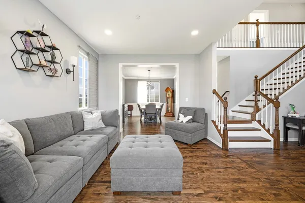 a living room with furniture or stairs and a wooden floor
