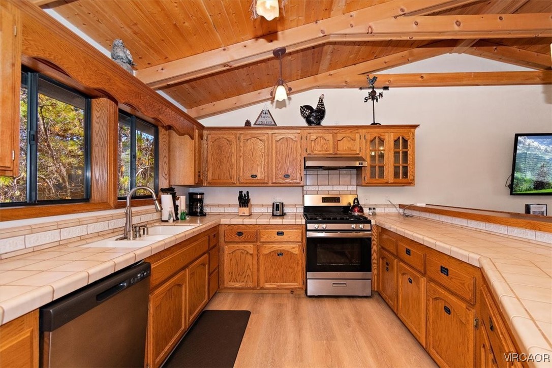 1584 Wolf Road Big Bear City, CA 92314 - Photo 13 of 33 a large kitchen with stainless steel appliances granite countertop a stove and a sink