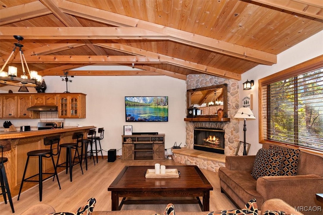 1584 Wolf Road Big Bear City, CA 92314 - Photo 15 of 33 a living room with furniture a flat screen tv and a fireplace