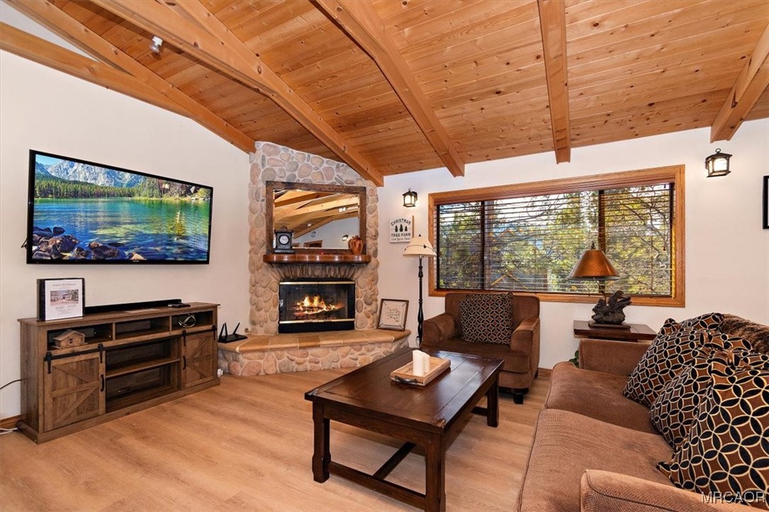 1584 Wolf Road Big Bear City, CA 92314 - Photo 17 of 33 a living room with furniture a flat screen tv and floor to ceiling window