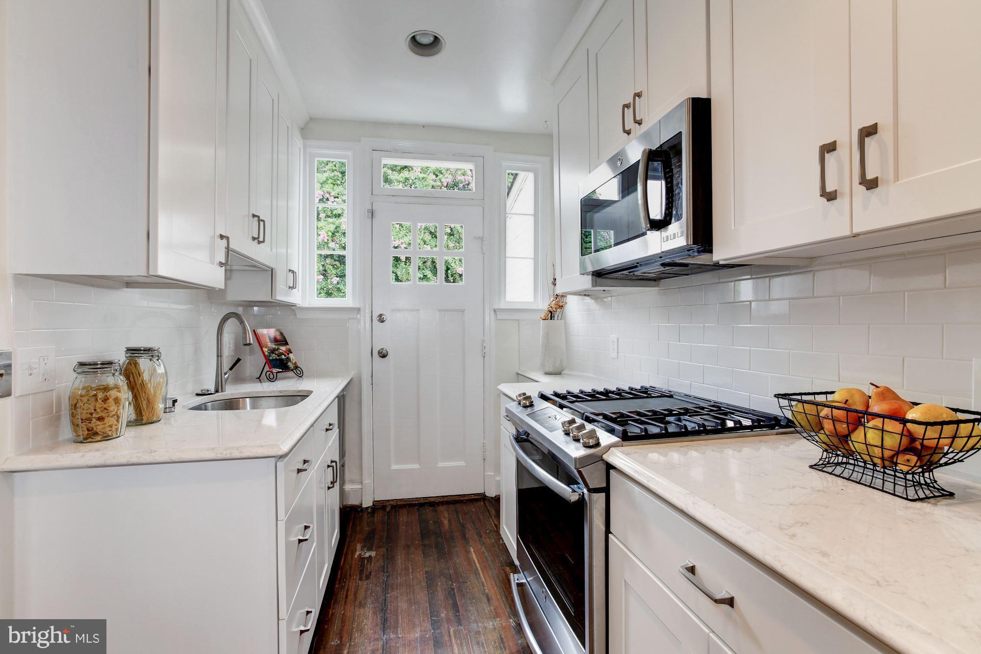 3523 S Street Northwest Washington, DC 20007 - Photo 4 of 15 a kitchen with stainless steel appliances granite countertop a sink stove and cabinets