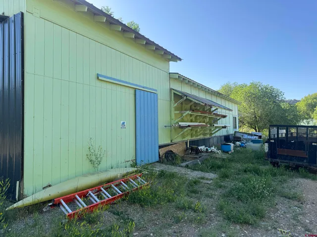 a view of a chair and tables in the backyard