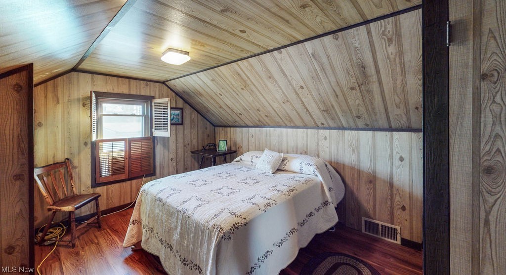 3180 Boston Road Brunswick, OH 44212 - Photo 21 of 41 Bedroom with dark wood-type flooring, wood walls, wooden ceiling, and vaulted ceiling