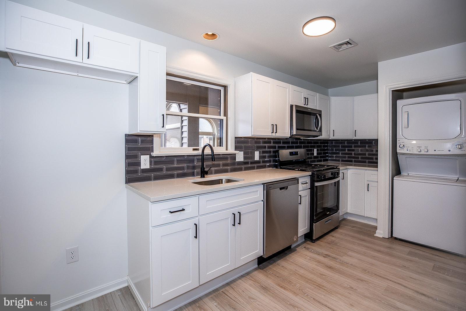 24 Amberly Way Lititz, PA 17543 - Photo 11 of 38 a kitchen with white cabinets sink and stainless steel appliances