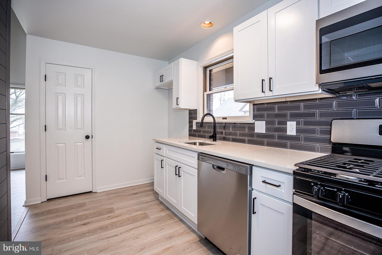 24 Amberly Way Lititz, PA 17543 - Photo 14 of 38 a kitchen with stainless steel appliances granite countertop a stove a sink and a microwave