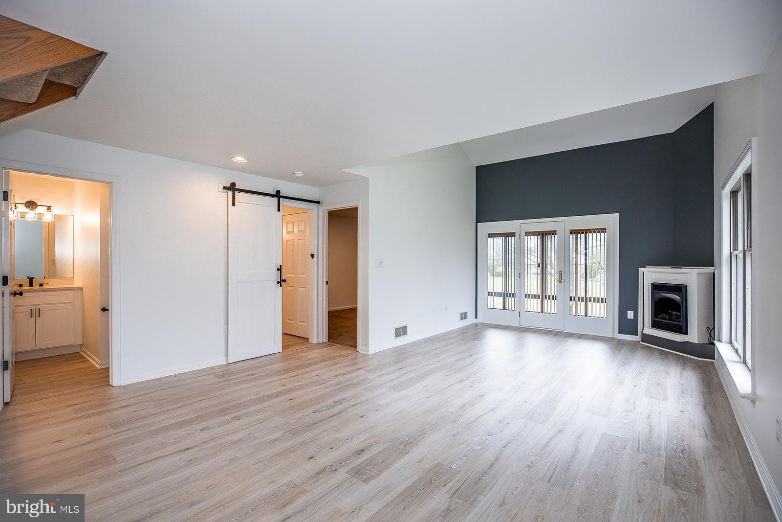 24 Amberly Way Lititz, PA 17543 - Photo 18 of 38 an empty room with wooden floor fireplace and windows