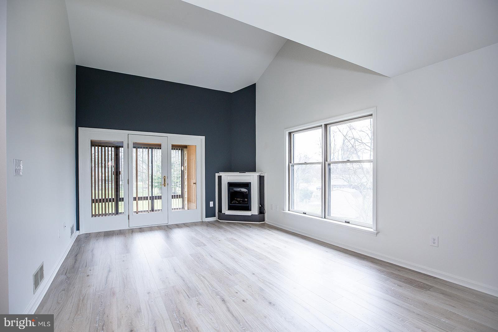 24 Amberly Way Lititz, PA 17543 - Photo 19 of 38 an empty room with wooden floor fireplace and windows