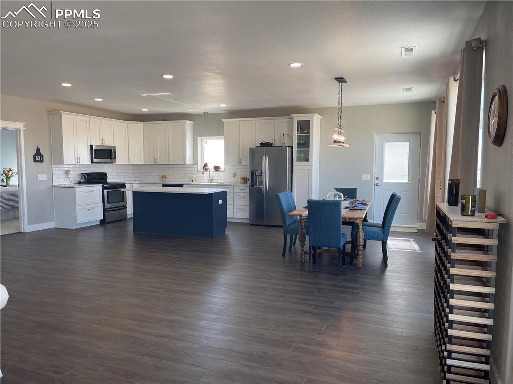 32215 Big Springs Road Yoder, CO 80864 - Photo 12 of 17 a view of a dining room with furniture and wooden floor