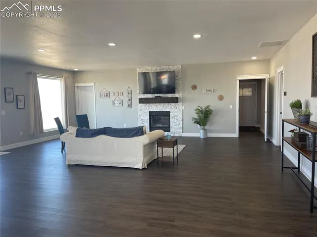 a living room with fireplace furniture and a flat screen tv