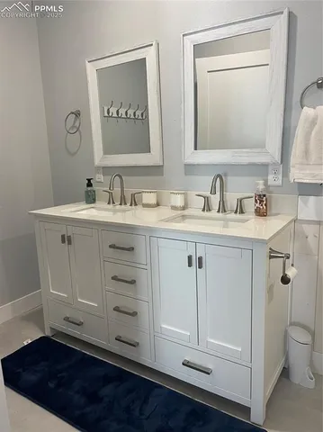 a bathroom with a sink vanity and a mirror