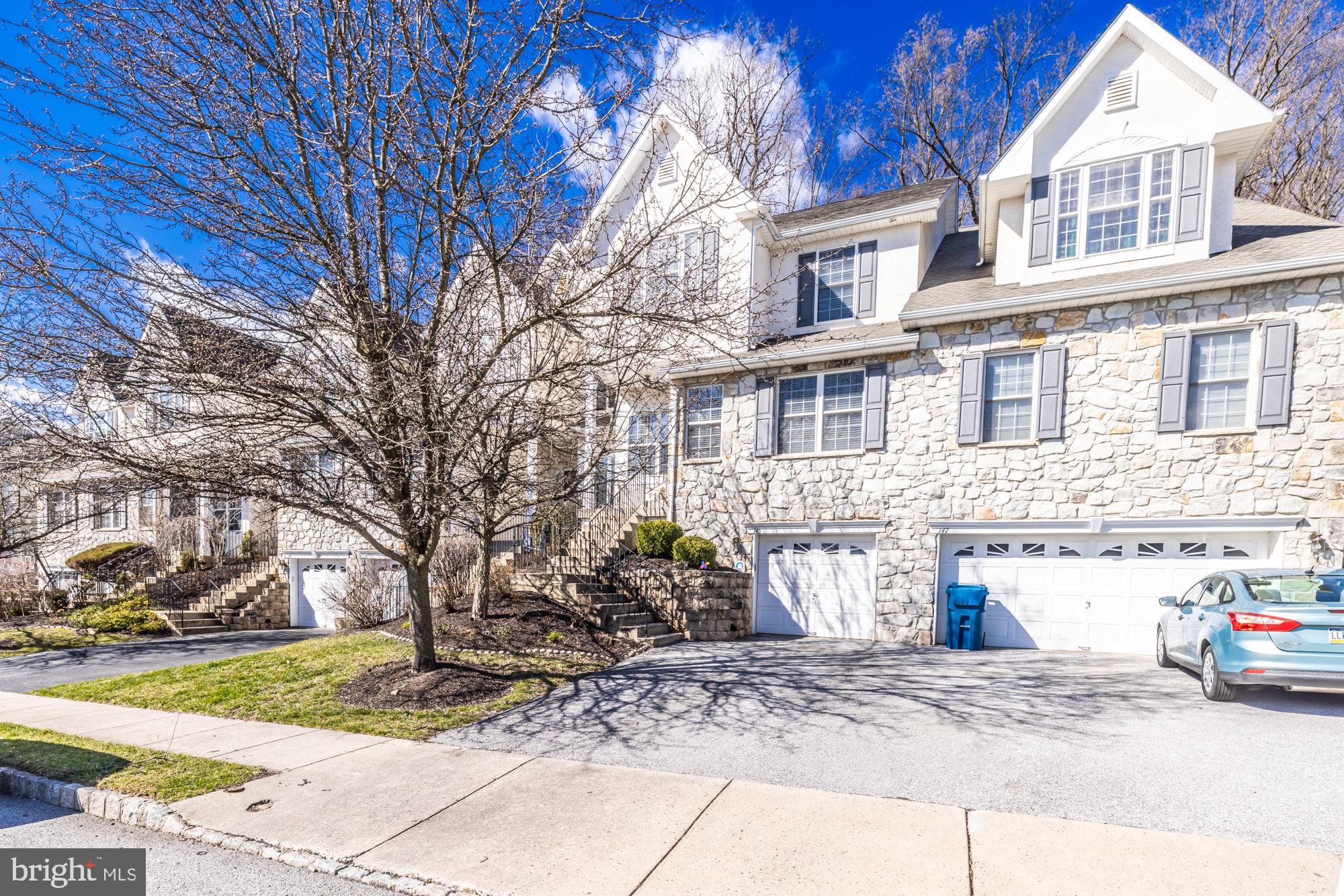 145 Madison Way Downingtown, PA 19335 - Photo 1 of 45 a front view of a house with garden