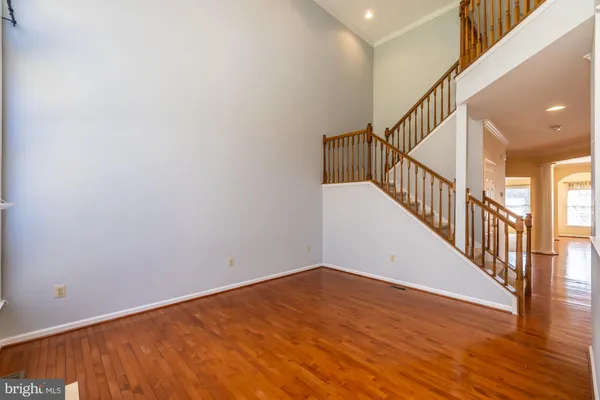 a view of room with wooden floor and stairs