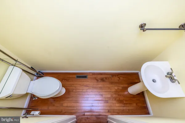 a bathroom with a sink mirror and toilet