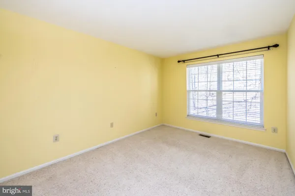 an empty room with a empty space and a window