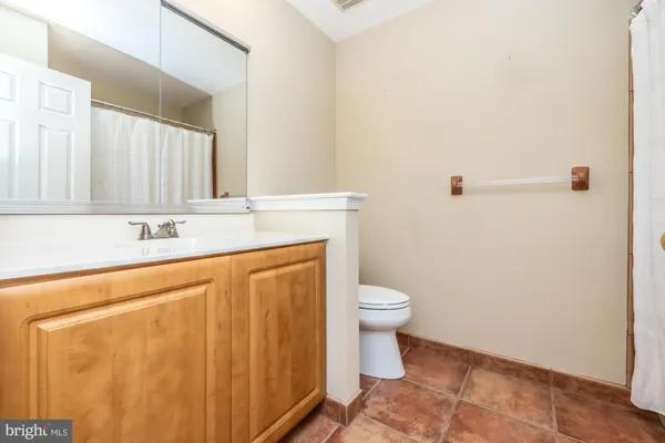 a bathroom with a sink a toilet and mirror