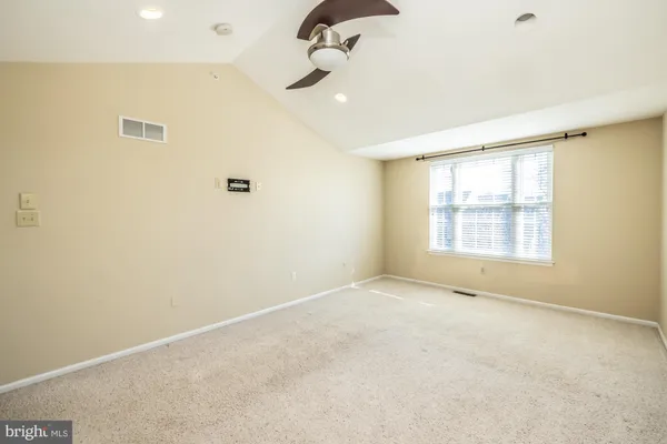 a view of empty room with ceiling fan