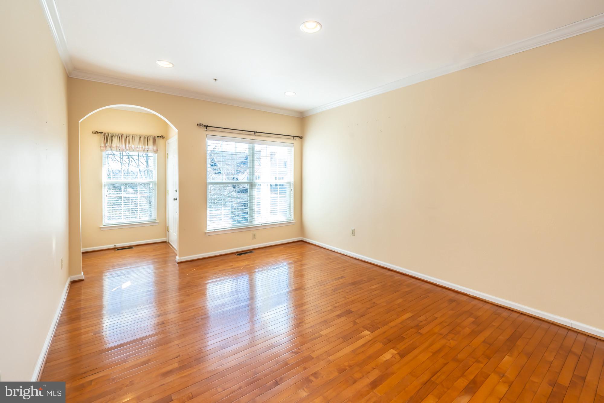 145 Madison Way Downingtown, PA 19335 - Photo 3 of 45 an empty room with wooden floor and windows