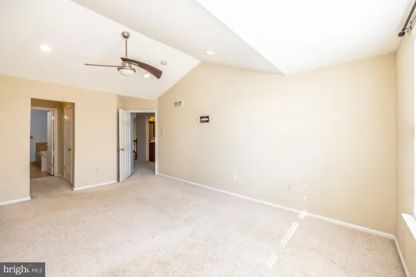 a spacious bathroom with a sink a toilet and a mirror