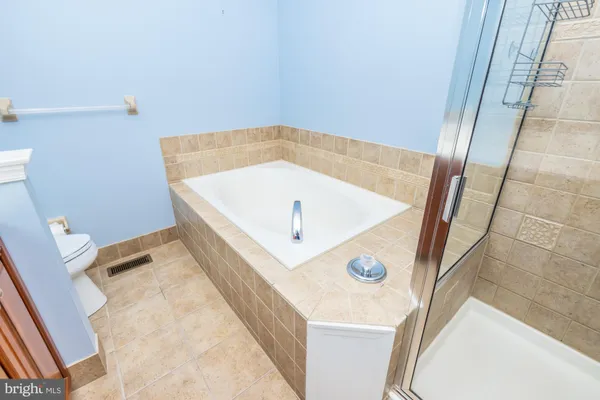 a bathroom with a bathtub and shower