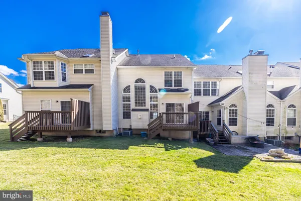 a view of a house with a yard patio and fire pit